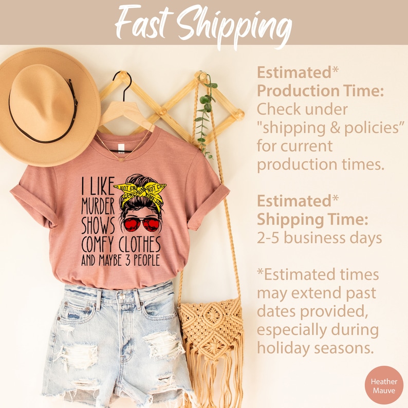 May include: A pink t-shirt with a graphic of a woman wearing sunglasses and a yellow headband with the text "I like murder shows, comfy clothes and maybe 3 people".