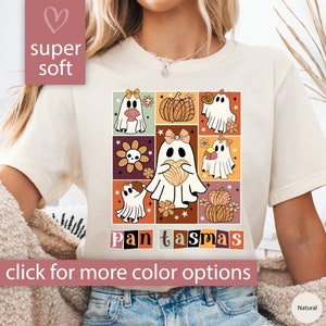 K&ouml;nnte beinhalten: Ein wei&szlig;es T-Shirt mit einem Motiv von niedlichen Geistern, die verschiedene Gegenst&auml;nde halten, darunter einen K&uuml;rbis, ein Herz und ein Geb&auml;ck. Der Text "pan tasmas" ist unter dem Motiv gedruckt.