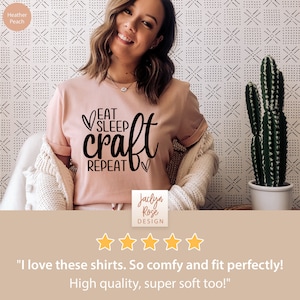 May include: A pink t-shirt with the text "Eat Sleep Craft Repeat" in black lettering. The shirt is being worn by a person and has a five-star rating.