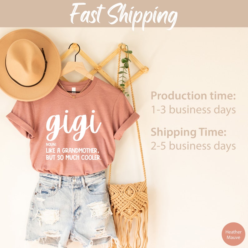 May include: A heather mauve t-shirt with the word "gigi" written in white cursive lettering. The shirt has the definition of "gigi" written below the word, which reads "NOUN: LIKE A GRANDMOTHER, BUT SO MUCH COOLER."