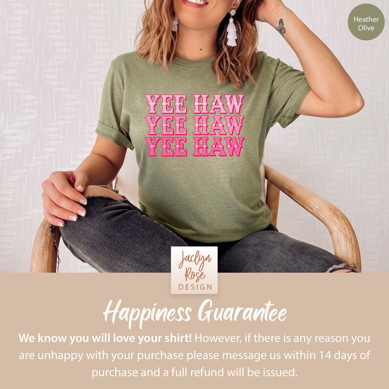 May include: A green t-shirt with the phrase "Yee Haw" repeated three times in pink lettering. The shirt is being modeled by a person. The text "Happiness Guarantee" is at the bottom of the image.
