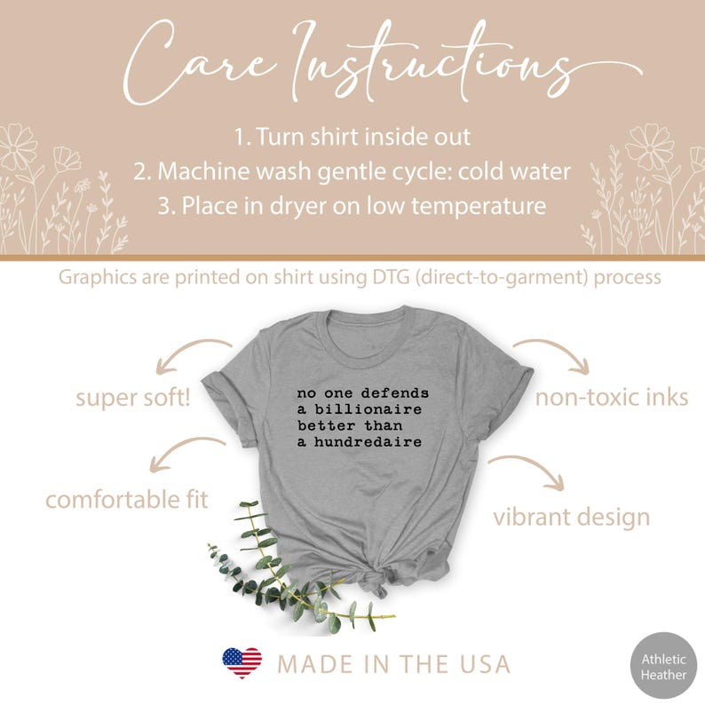 K&ouml;nnte beinhalten: Ein heidefarbenes T-Shirt mit dem Aufdruck "no one defends a billionaire better than a hundredaire". Das Shirt ist in den USA hergestellt und bietet eine bequeme Passform, superweiches Material, ungiftige Tinten und ein lebendiges Design.