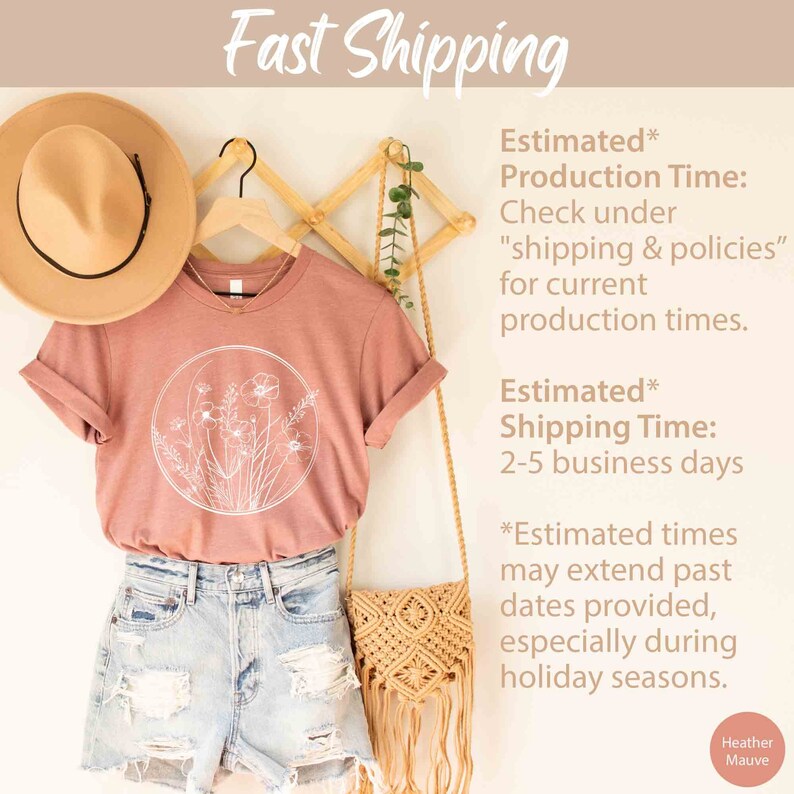 May include: A heather mauve t-shirt with a white floral design in a circle. The t-shirt is hanging on a wooden hanger with a straw hat and a woven bag. The text "Fast Shipping" is at the top of the image. The text "Estimated* Production Time: Check under "shipping & policies" for current production times." is in the upper right corner. The text "Estimated* Shipping Time: 2-5 business days" is in the middle right corner. The text "*Estimated times may extend past dates provided, especially during holiday seasons." is in the lower right corner. The text "Heather Mauve" is in the lower right corner.