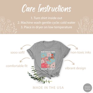 May include: Gray t-shirt with a floral design and the text "basic human rights are not 'radical'" printed on the front. The shirt is made in the USA.