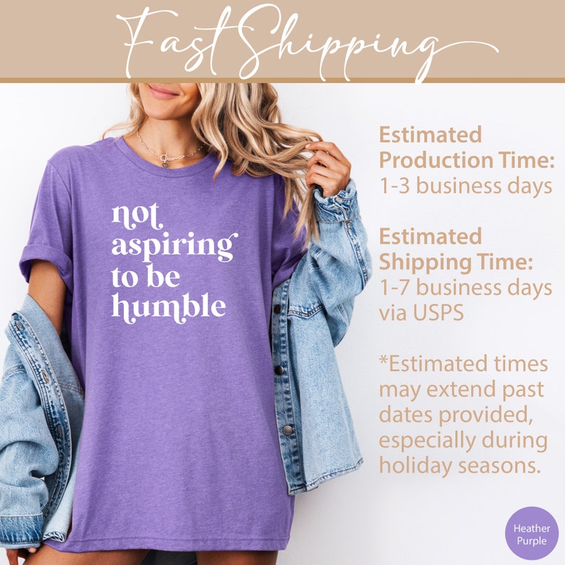 May include: Purple heather t-shirt with the text "not aspiring to be humble" printed in white.