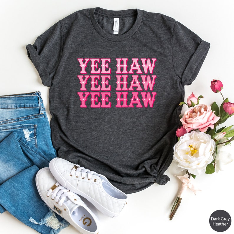 May include: Dark grey heather t-shirt with the text "YEE HAW" repeated three times in pink.