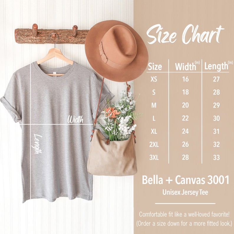 May include: Size chart for a Bella + Canvas 3001 Unisex Jersey Tee. The chart shows the width and length in inches for sizes XS to 3XL. The image also shows a gray t-shirt hanging on a wooden rack.