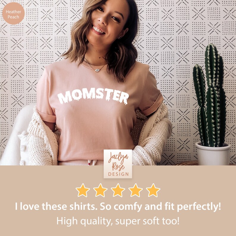 May include: A pink t-shirt with the text "MOMSTER" in white dripping letters. The shirt is worn by a person and is photographed against a white and black patterned background. The text "Jaclyn Rose DESIGN" is visible in the bottom right corner of the image. Five gold stars are displayed below the text. The text "I love these shirts. So comfy and fit perfectly! High quality, super soft too!" is displayed below the stars.