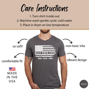 May include: A gray t-shirt with a white distressed American flag design and the text "BEST PAPA EVER" with names below. The shirt is made in the USA and features a comfortable fit, soft fabric, non-toxic inks, and a vibrant design.