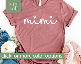 May include: A mauve colored t-shirt with the word "mimi" written in white with two small hearts above and below the word.