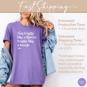 May include: Purple heather t-shirt with white text that reads "Not fragile like a flower, fragile like a bomb. -RBG"