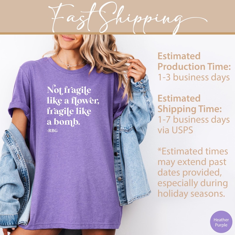 May include: Purple heather t-shirt with white text that reads "Not fragile like a flower, fragile like a bomb. -RBG"