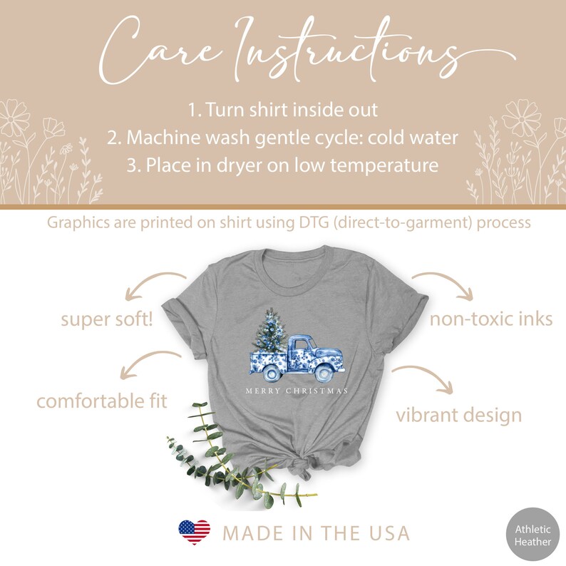 May include: A gray t-shirt with a blue and white watercolor design of a pickup truck carrying a Christmas tree. The text "Merry Christmas" is printed below the truck. The shirt is made in the USA and is super soft, comfortable, and features non-toxic inks.