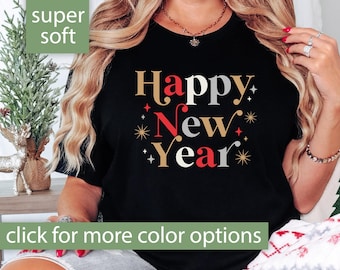 May include: Black t-shirt with the text "Happy New Year" in red, gold, and white lettering with stars. The shirt is super soft.