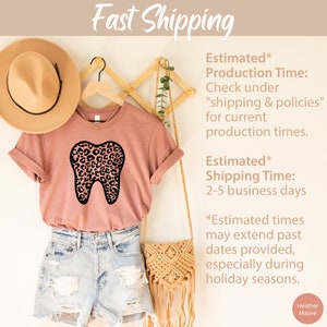 May include: A heather mauve t-shirt with a black and pink leopard print tooth graphic. The text "Fast Shipping" is at the top of the image. The text "Estimated* Production Time: Check under "shipping & policies" for current production times." is on the right side of the image. The text "Estimated* Shipping Time: 2-5 business days" is also on the right side of the image. The text "*Estimated times may extend past dates provided, especially during holiday seasons." is on the right side of the image. The text "Heather Mauve" is at the bottom right of the image.