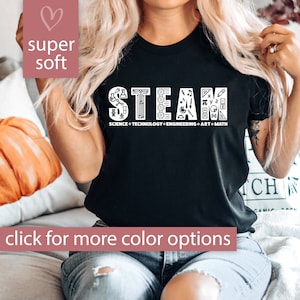 May include: Black t-shirt with the word "STEAM" in white letters, surrounded by icons representing science, technology, engineering, art, and math. The text below the word "STEAM" reads "SCIENCE TECHNOLOGY ENGINEERING ART MATH".