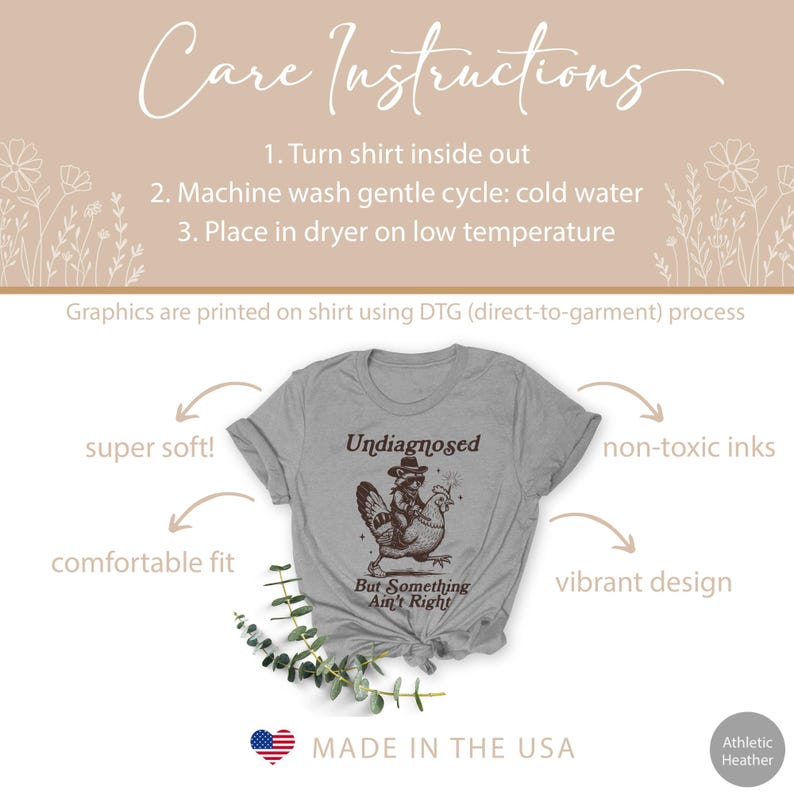May include: Athletic heather gray t-shirt with the text "Undiagnosed But Something Ain't Right" and a graphic of a raccoon riding a chicken. The shirt also has care instructions and is labeled "Made in the USA".