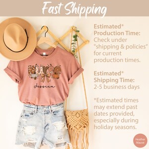 May include: A heather mauve t-shirt with a fall-themed "Nurse" graphic and the name "Jessica" printed on the front. The shirt is displayed on a hanger with a straw hat and a woven bag.