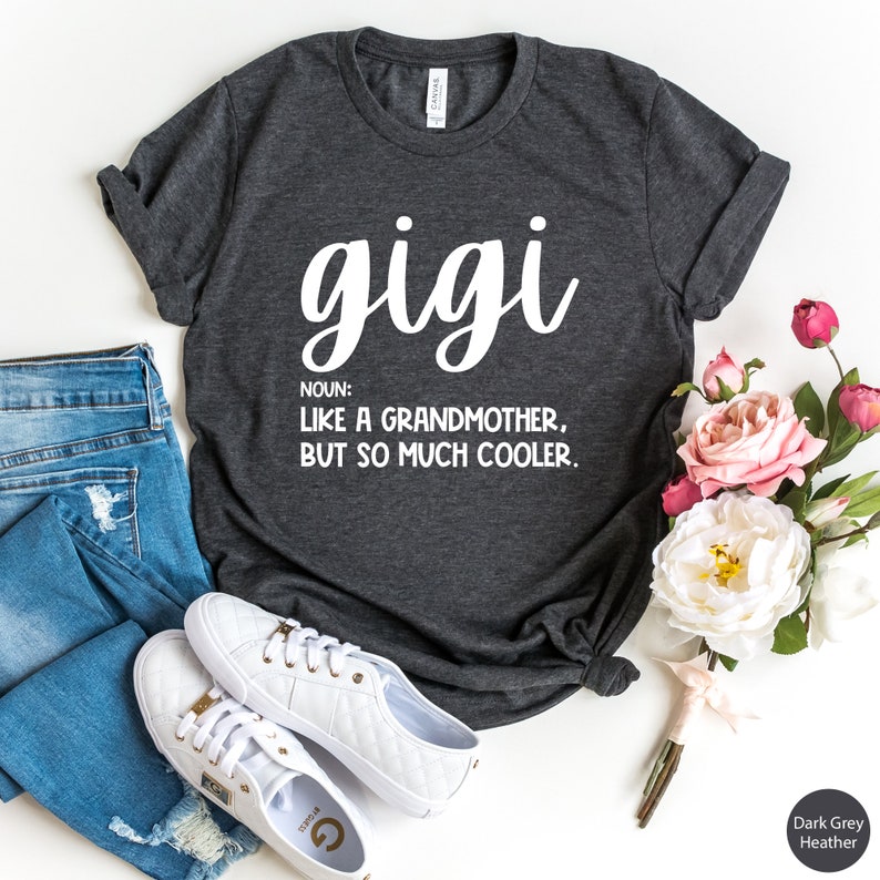 May include: Dark grey heather t-shirt with white text that reads "gigi" and "NOUN: LIKE A GRANDMOTHER, BUT SO MUCH COOLER."