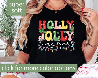 May include: Black t-shirt with a colorful "Holly Jolly Teacher" graphic and Christmas lights. The shirt is super soft.