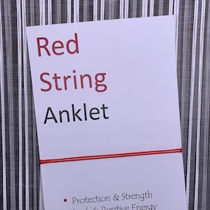 May include: Red string anklet with the text "Protection & Strength", "Luck & Positive Energy", "Fortune & Wealth", and "Connection & Destiny".
