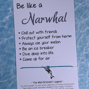 May include: A blue and silver wish bracelet with a narwhal charm. The card attached to the bracelet reads "Be like a Narwhal" and lists several qualities, including "Chill out with friends", "Protect yourself from harm", and "Always use your melon". The card also includes the text "The Wish Bracelet Legend" and explains how to use the bracelet to make a wish.