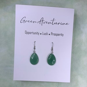 May include: Green aventurine teardrop earrings with silver hooks. The card reads "Green Aventurine" and "Opportunity, Luck, Prosperity".