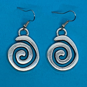 May include: A pair of silver earrings with a blue swirl design. The earrings are dangle style with a hook closure.