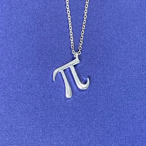 May include: A silver necklace with a pi symbol pendant.