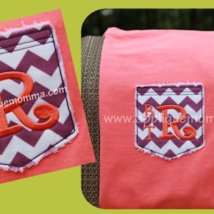 May include: A pink t-shirt with a purple and white chevron pocket. The pocket has a large orange letter "R" and the letters "BT" embroidered on it. The text "www.appliquemamma.com" is also embroidered on the pocket.