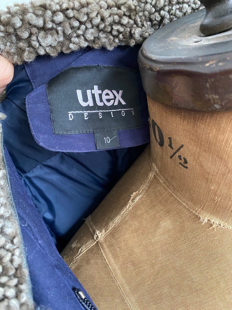 Navy sueded long down filled puffer jacket with fur trim Size LXL.