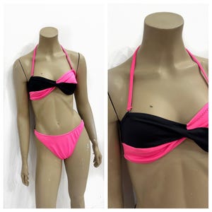 Spicy 1990’s black and hot pink high cut bikini with a twist top. Size XS/S.