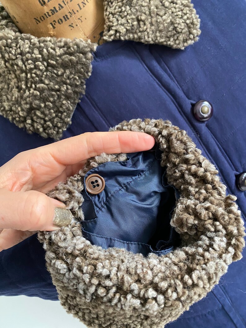 Navy sueded long down filled puffer jacket with fur trim Size LXL.