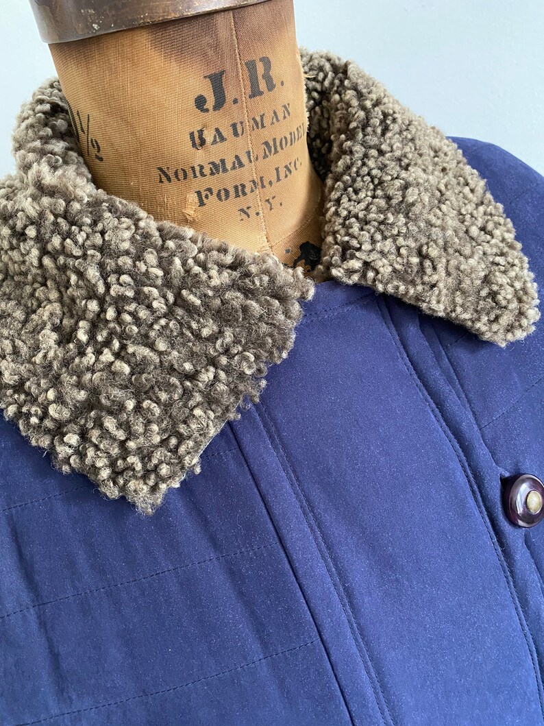 Navy sueded long down filled puffer jacket with fur trim Size LXL.