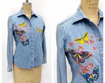Sweet denim button up with whimsical butterflies painted on it. Size S/M.
