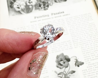 Vintage style sterling silver double prong set cubic zirconia solitaire ring. Size 8 and 9.