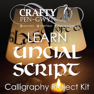 May include: Two translucent, cone-shaped lampshades featuring black calligraphy text, including the words GLASS and SOFT CALLIGRAPHY. The text CRAFTY PEN-GWYN with a penguin illustration appears at the top. A lit candle sits in the foreground.