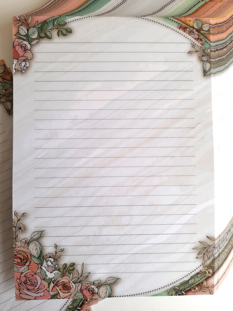 May include: A white lined paper with a floral border. The border features pink roses, green leaves, and a dotted line.