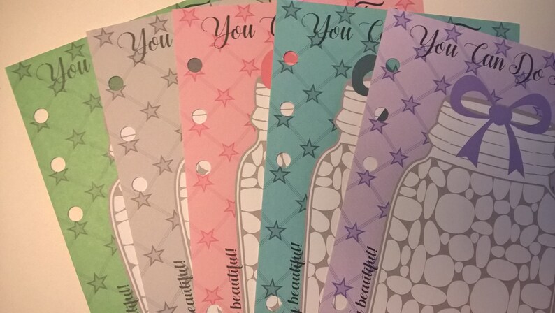 May include: Five printable cards with a jar of rocks design. The cards are in different colors: green, gray, pink, blue, and purple. Each card has the text "You" or "You Can Do" and the phrase "so beautiful!" at the bottom.