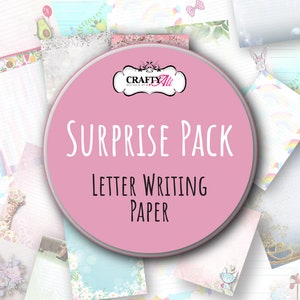 May include: A pink circular graphic with the words "SURPRISE PACK" and "LETTER WRITING PAPER" in white text. The graphic is surrounded by various sheets of decorative stationery with pastel colors and patterns, including avocados, rainbows, and floral designs.