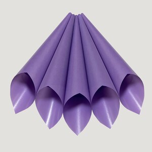 May include: A set of six purple paper cones, folded and arranged in a fan shape. The cones are made of a smooth, slightly shiny paper.