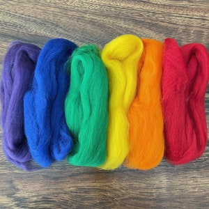 May include: Six skeins of wool yarn in rainbow colors: indigo, blue, green, yellow, orange, and red.