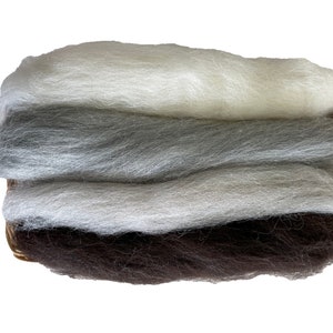 May include: A basket filled with four layers of wool roving in shades of white, gray, and brown.