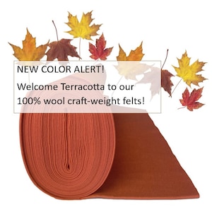 May include: A roll of terracotta-colored 100% wool felt. The felt is rolled up and the end is laying flat. The text "NEW COLOR ALERT! Welcome Terracotta to our 100% wool craft-weight felts!" is displayed above the felt.
