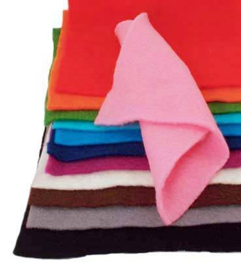 May include: A stack of felt fabric sheets in various colors, including black, gray, brown, white, purple, blue, green, orange, and red. A pink felt sheet is folded and placed on top of the stack.