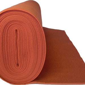 May include: A roll of orange felt fabric. The felt is rolled up tightly and the end of the roll is visible.
