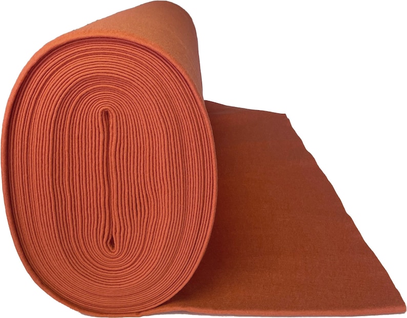 May include: A roll of orange felt fabric. The felt is rolled up tightly and the end of the roll is visible.