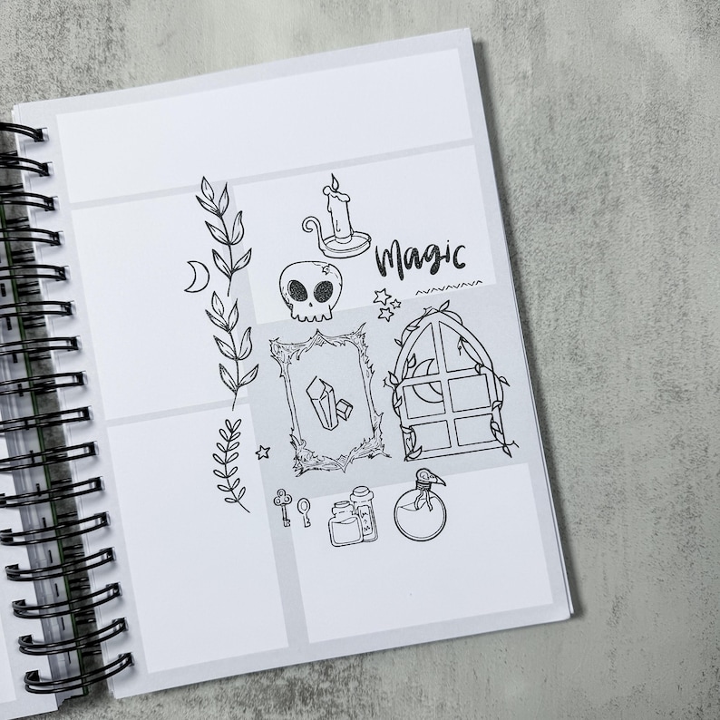 May include: A spiral-bound notebook with a white interior featuring black line art. The illustrations include a skull, candle, crystals, a window, and the word "Magic". The notebook is open, revealing the detailed drawings.