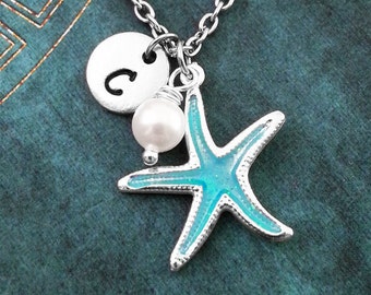 May include: A silver necklace with a blue starfish charm, a pearl bead, and a silver charm with the letter "C" on it.