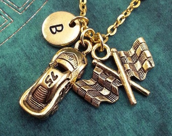 May include: Gold necklace with a charm of a race car, a checkered flag, and a letter B charm. *race car number can't be changed*
